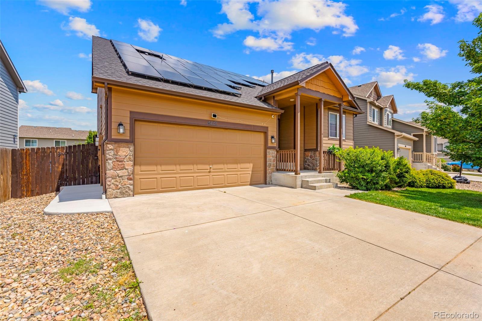 4651 Dancing Rain Way Colorado Springs, CO 80911 - Photo 2 of 32 a front view of a house with a yard and garage