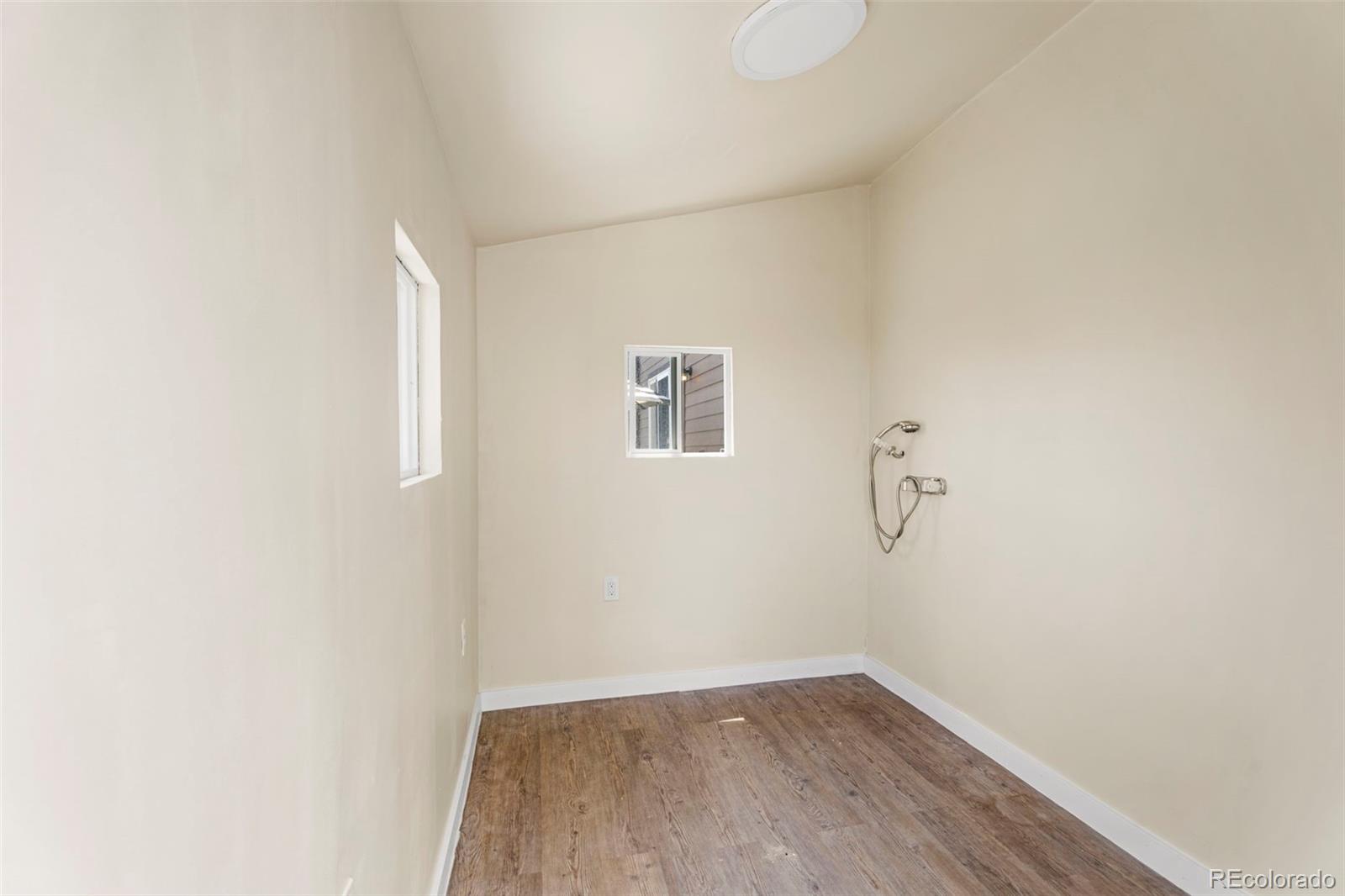 4651 Dancing Rain Way Colorado Springs, CO 80911 - Photo 24 of 32 a view of a small space with wooden floor and a window
