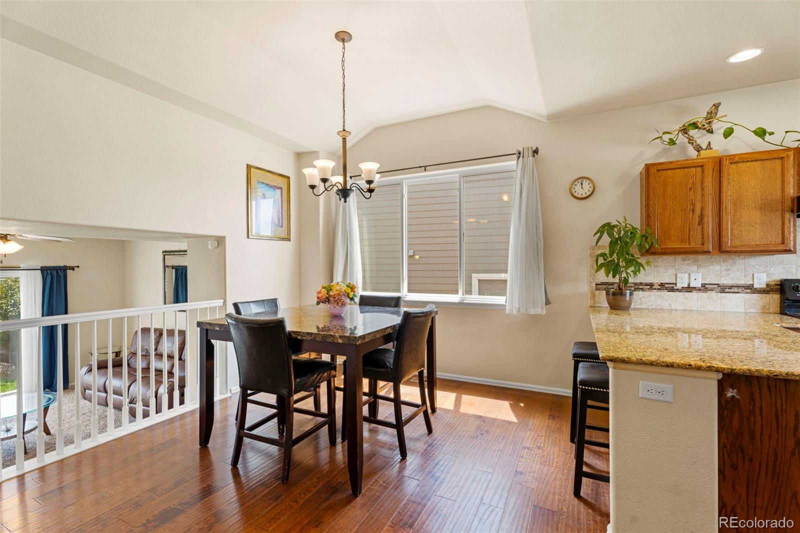 4651 Dancing Rain Way Colorado Springs, CO 80911 - Photo 5 of 32 a view of a dining room with furniture window and wooden floor