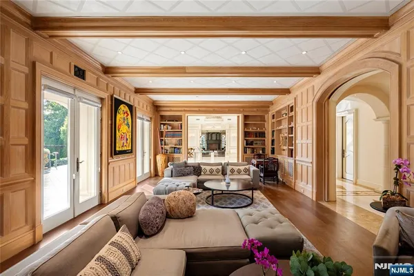 a living room with furniture and floor to ceiling windows