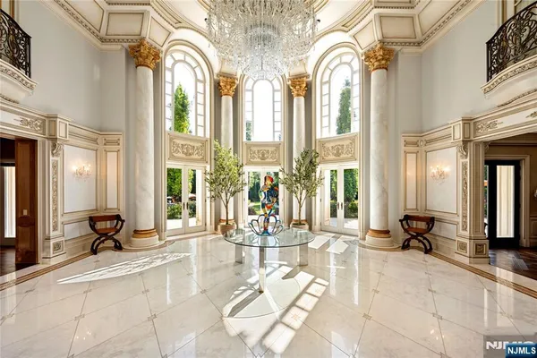 a lobby with furniture and floor to ceiling windows