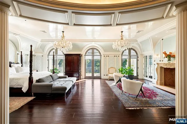 a living room with fireplace furniture and wooden floor