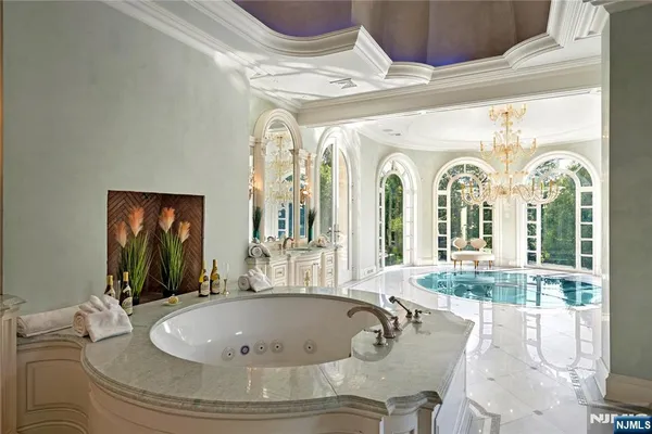 a view of a dining room with balcony furniture and a chandelier