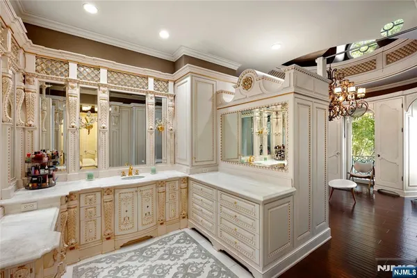 a spacious bathroom with a granite countertop sink a mirror and a shower