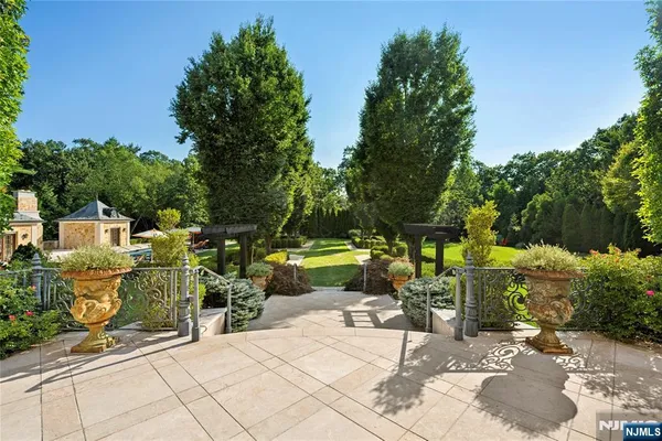 a backyard of a house with barbeque oven table and chairs