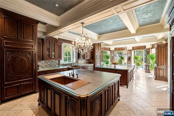 a kitchen with a sink a counter top space and stainless steel appliances