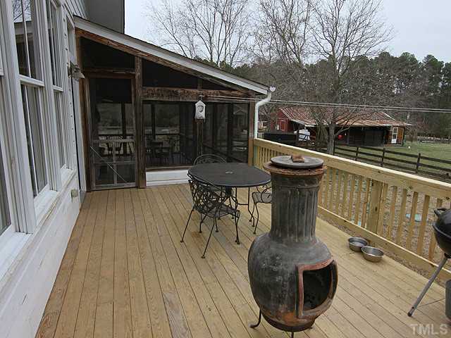 3511 Carpenter Pond Road Durham, NC 27703 - Photo 19 of 25 Step Out of Your Screen Porch and Enjoy the Deck Overlooking the Private Lush Grounds and Pond. Fenced Pasture with Barn Awaits Your Horses.