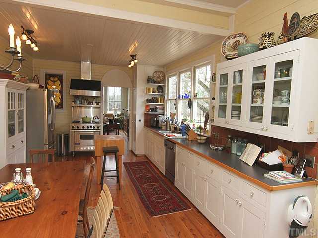 3511 Carpenter Pond Road Durham, NC 27703 - Photo 6 of 25 Stunning TRUE Country Kitchen. Offers Awesome Hardwood Floors-Custom White Cabinets- Wolf Gas Range for the Gourmet Country Cook! This Kitchen Invites ALL Your Family & Friends Room to Gather.