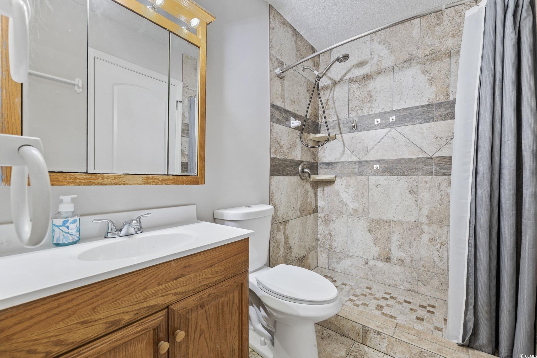 801 Burcale Road, Unit I1 Myrtle Beach, SC 29579 - Photo 15 of 27 Bathroom with vanity and a stall shower