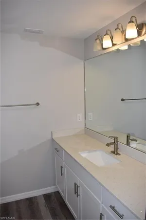 a bathroom with a sink and vanity