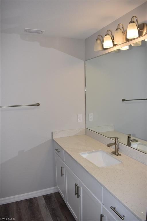 2295 Saturday Street North Port, FL 34288 - Photo 13 of 20 Bathroom featuring vanity and dark wood-style flooring