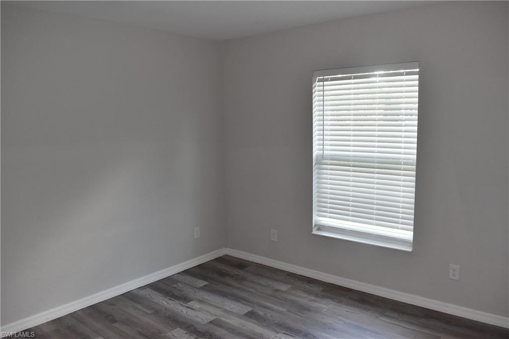 2295 Saturday Street North Port, FL 34288 - Photo 15 of 20 Empty room featuring baseboards and dark wood-type flooring