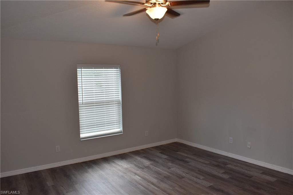 2295 Saturday Street North Port, FL 34288 - Photo 16 of 20 Empty room with dark wood finished floors and ceiling fan
