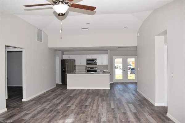 a living room with stainless steel appliances kitchen island granite countertop furniture and a kitchen view