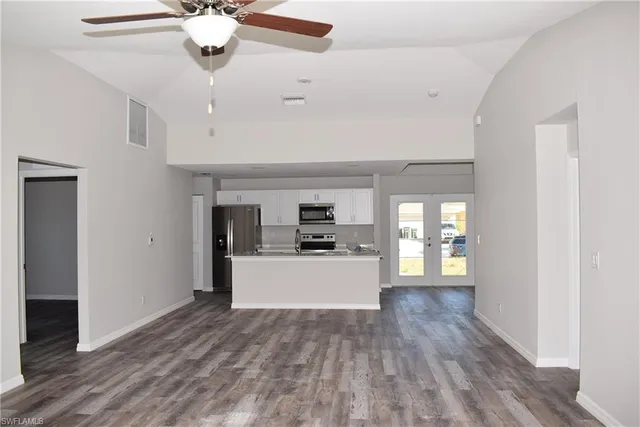 a living room with stainless steel appliances kitchen island granite countertop furniture and a kitchen view