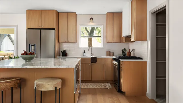 a kitchen with stainless steel appliances granite countertop a refrigerator sink and cabinets