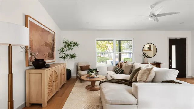 a living room with furniture a clock and a window