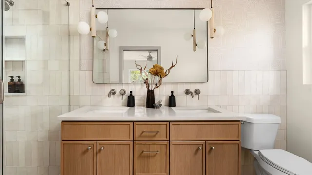 a bathroom with a granite countertop sink a toilet and a mirror