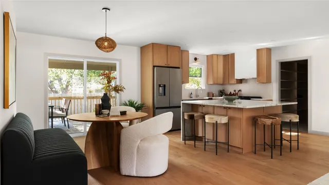 a dining room with furniture a window and stainless steel appliances
