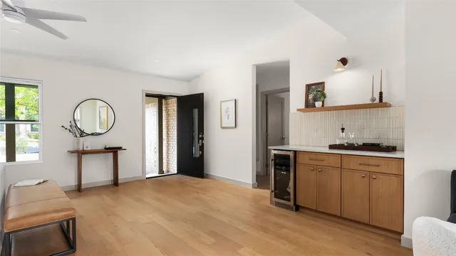 a living room with stainless steel appliances granite countertop furniture a fireplace and a window