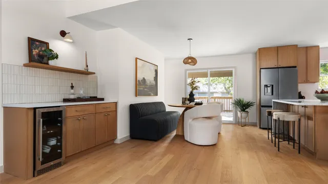 a living room with furniture a dining table and kitchen view