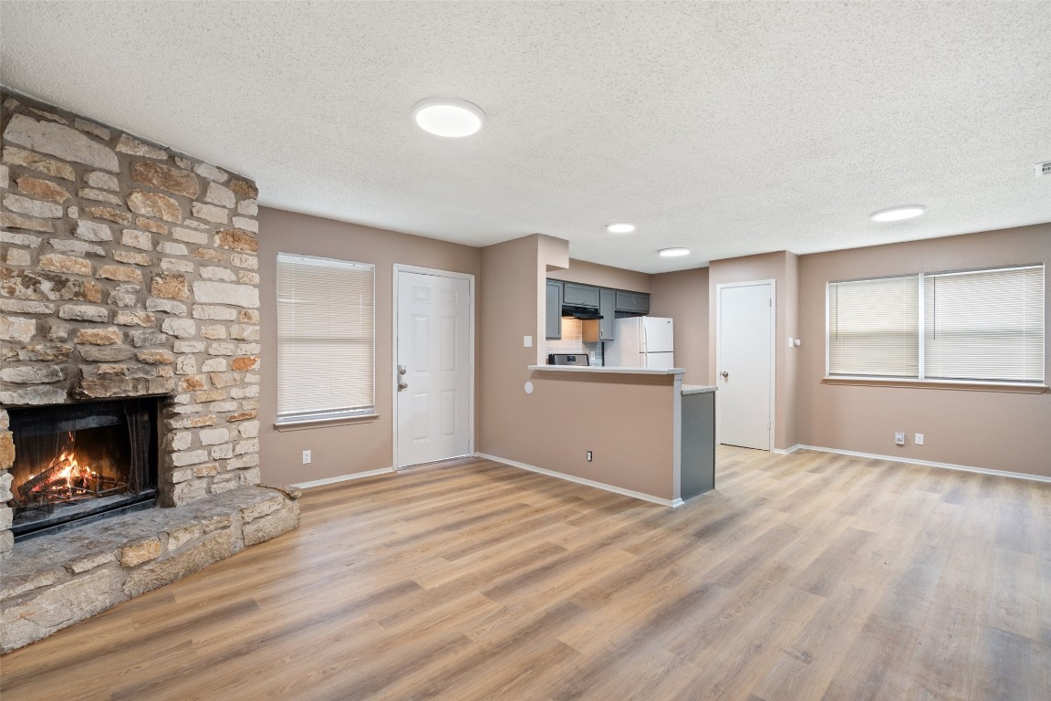 2312 Rachael Court, Unit C Austin, TX 78748 - Photo 1 of 13 a view of empty room with wooden floor and fireplace