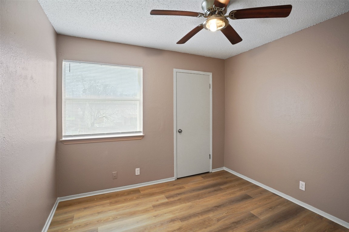 2312 Rachael Court, Unit C Austin, TX 78748 - Photo 12 of 13 an empty room with a window and a fan