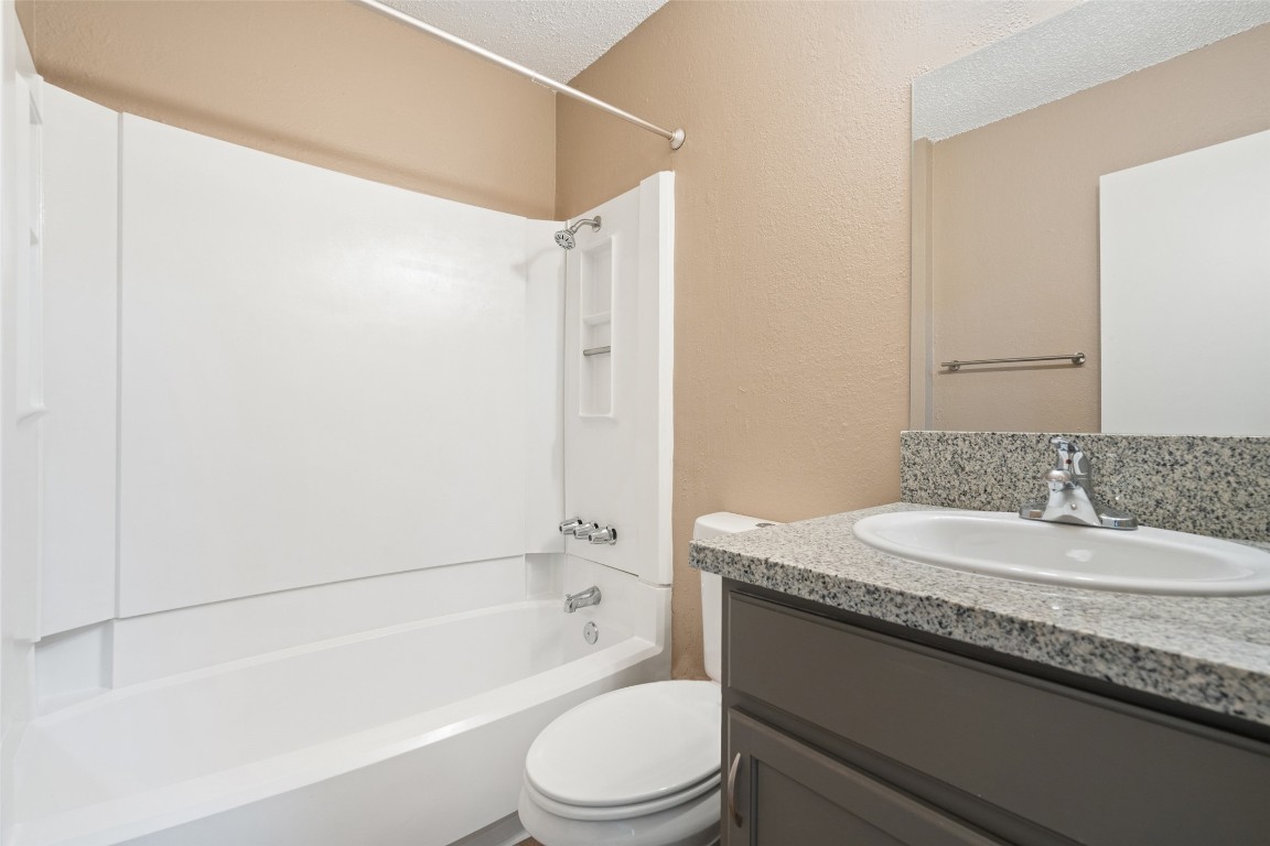 2312 Rachael Court, Unit C Austin, TX 78748 - Photo 13 of 13 a bathroom with a granite countertop sink toilet and shower