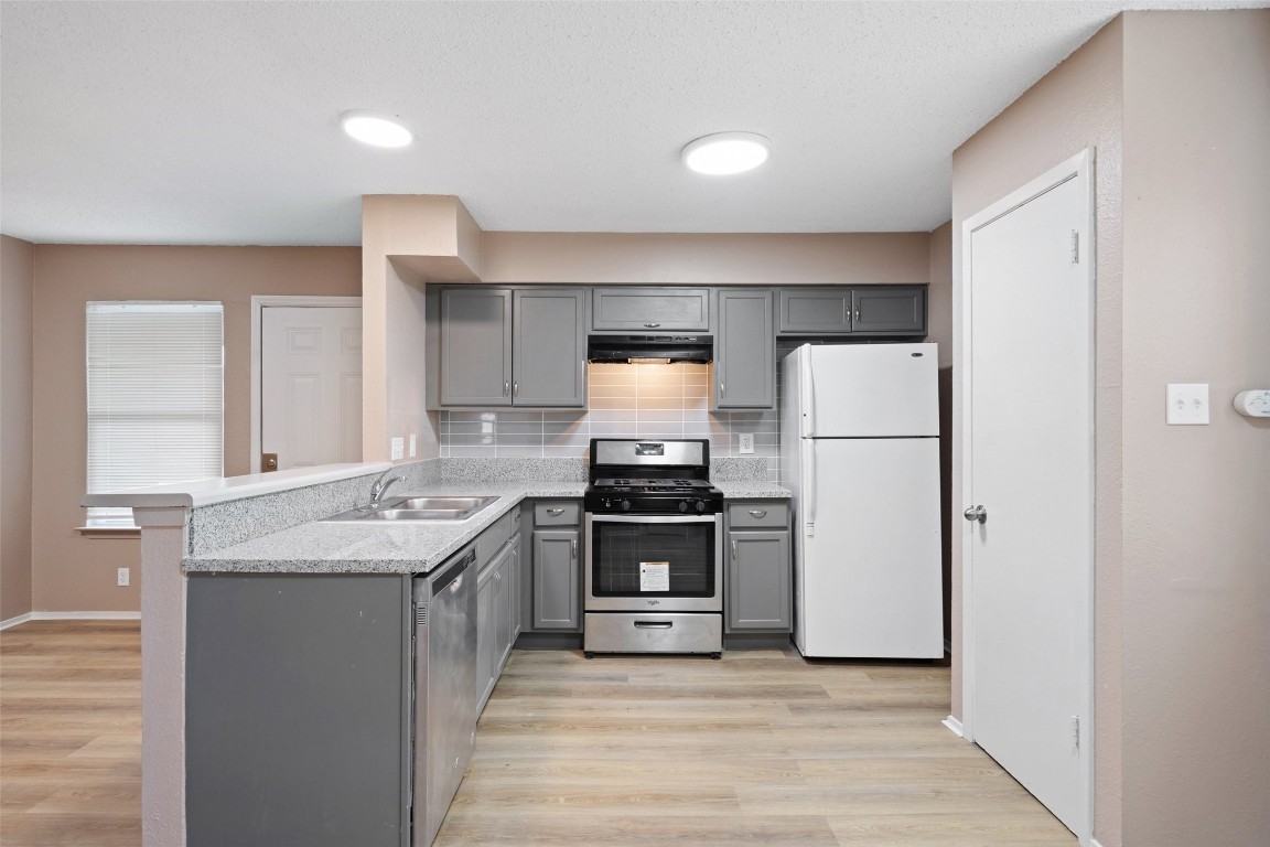 2312 Rachael Court, Unit C Austin, TX 78748 - Photo 4 of 13 a kitchen with a sink stove and refrigerator