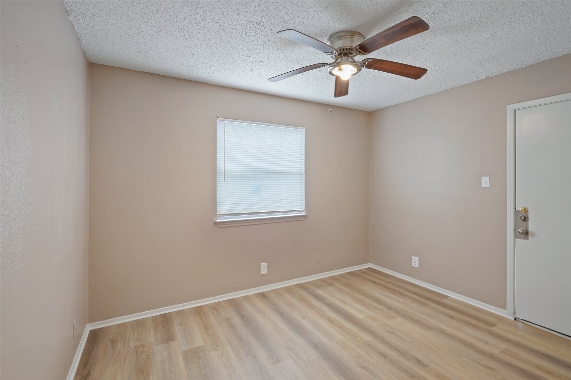 2312 Rachael Court, Unit C Austin, TX 78748 - Photo 9 of 13 an empty room with a window and a fan