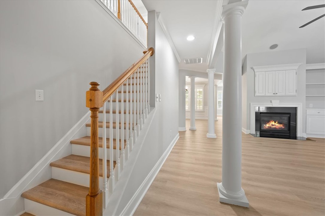 100 Shipyard Circle Anderson, SC 29621 - Photo 7 of 40 This bright interior features a classic staircase, elegant columns, and a cozy fireplace.