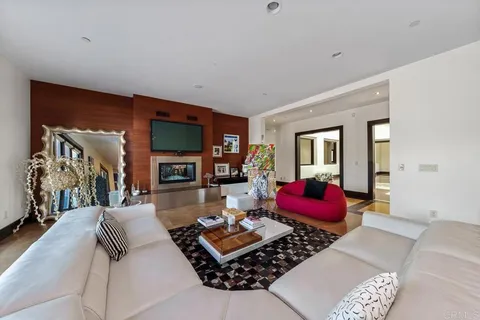 a living room with furniture fireplace and flat screen tv