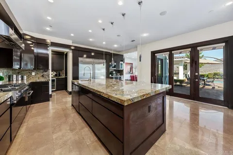a kitchen with a stove and a large window