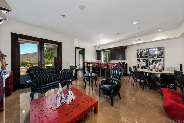 a view of a dining room with furniture and a flat screen tv