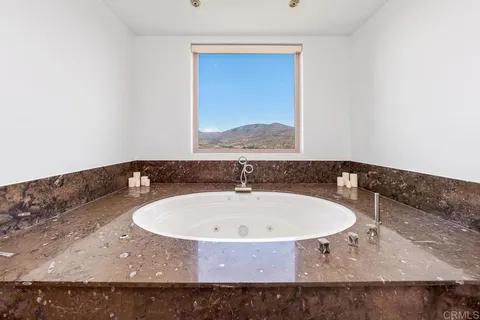 a bedroom with two beds and a flat screen tv