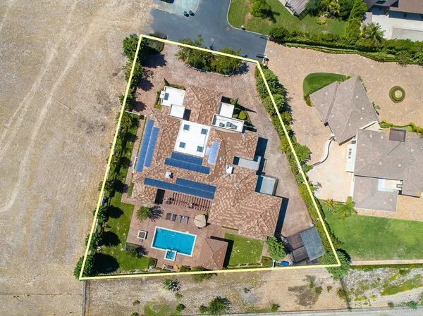 an aerial view of residential house and sandy dunes