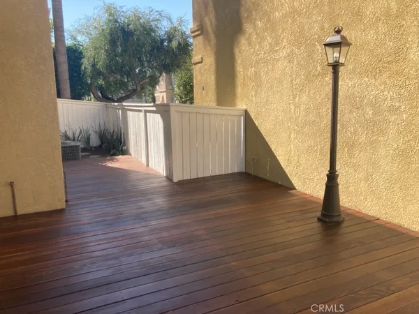 a view of a deck with wooden floor and a bench