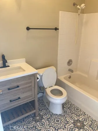 a bathroom with a sink a toilet and a bathtub