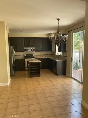 a kitchen with kitchen island a sink stainless steel appliances and cabinets