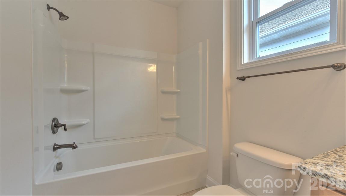 649 River Btm Road Fletcher, NC 28732 - Photo 18 of 40 a white bath tub sitting next to a white toilet