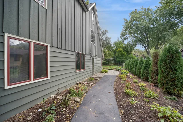a pathway of a house with a yard