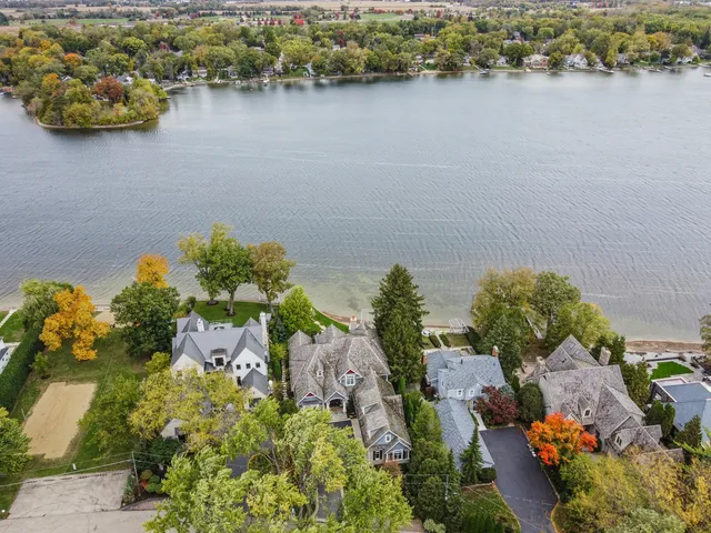 an aerial view of a house with a lake view