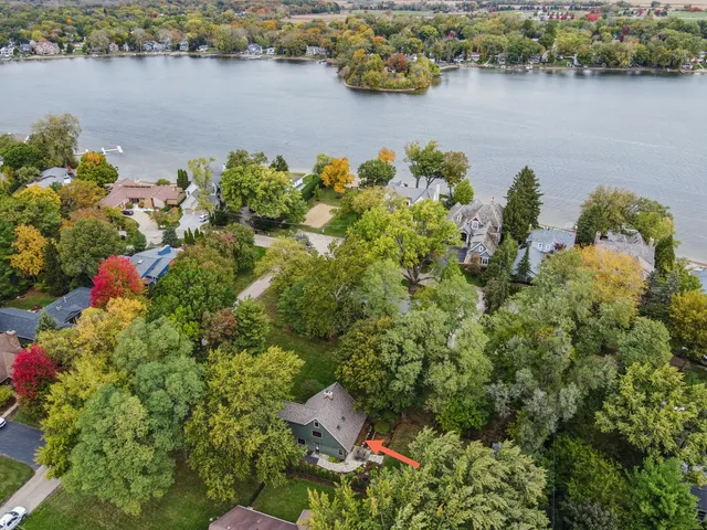 an aerial view of a houses with a lake view