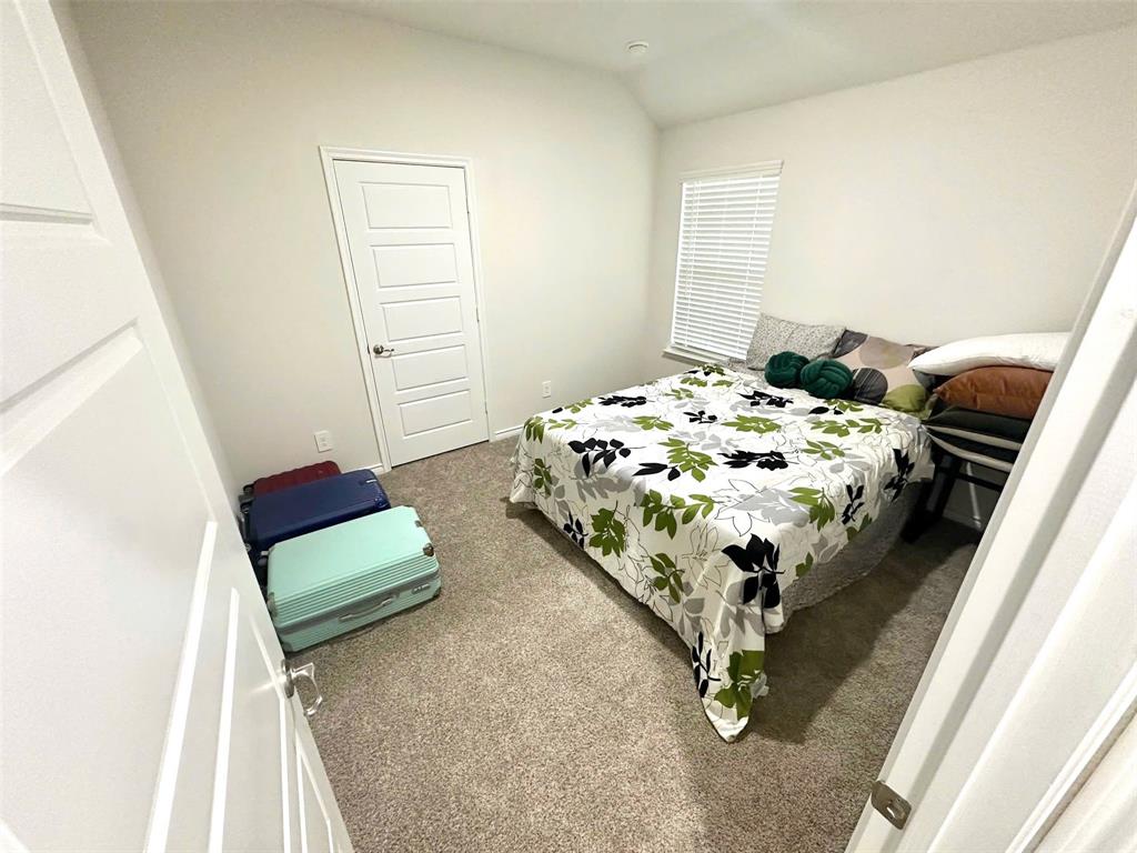 324 Revolution Road Fate, TX 75189 - Photo 10 of 15 Carpeted room with a modern five-panel interior door, neutral wall color, and a window featuring horizontal blinds