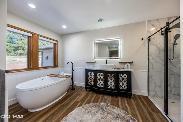 a bathroom with a double vanity sink mirror and shower