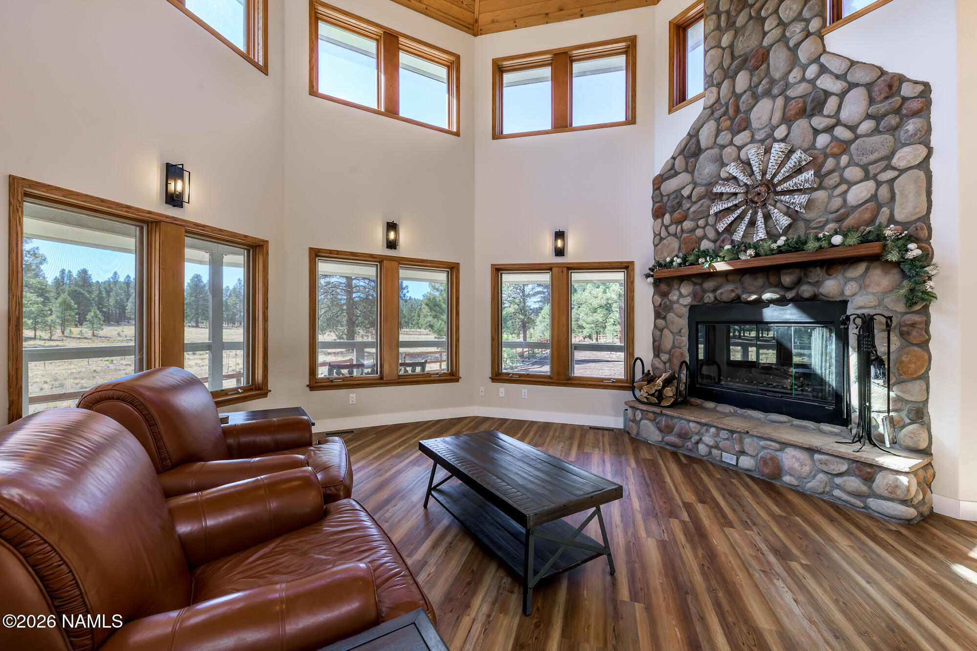 4540 Forest Ranches Loop Parks, AZ 86018 - Photo 20 of 60 a living room with furniture a flat screen tv and a fireplace