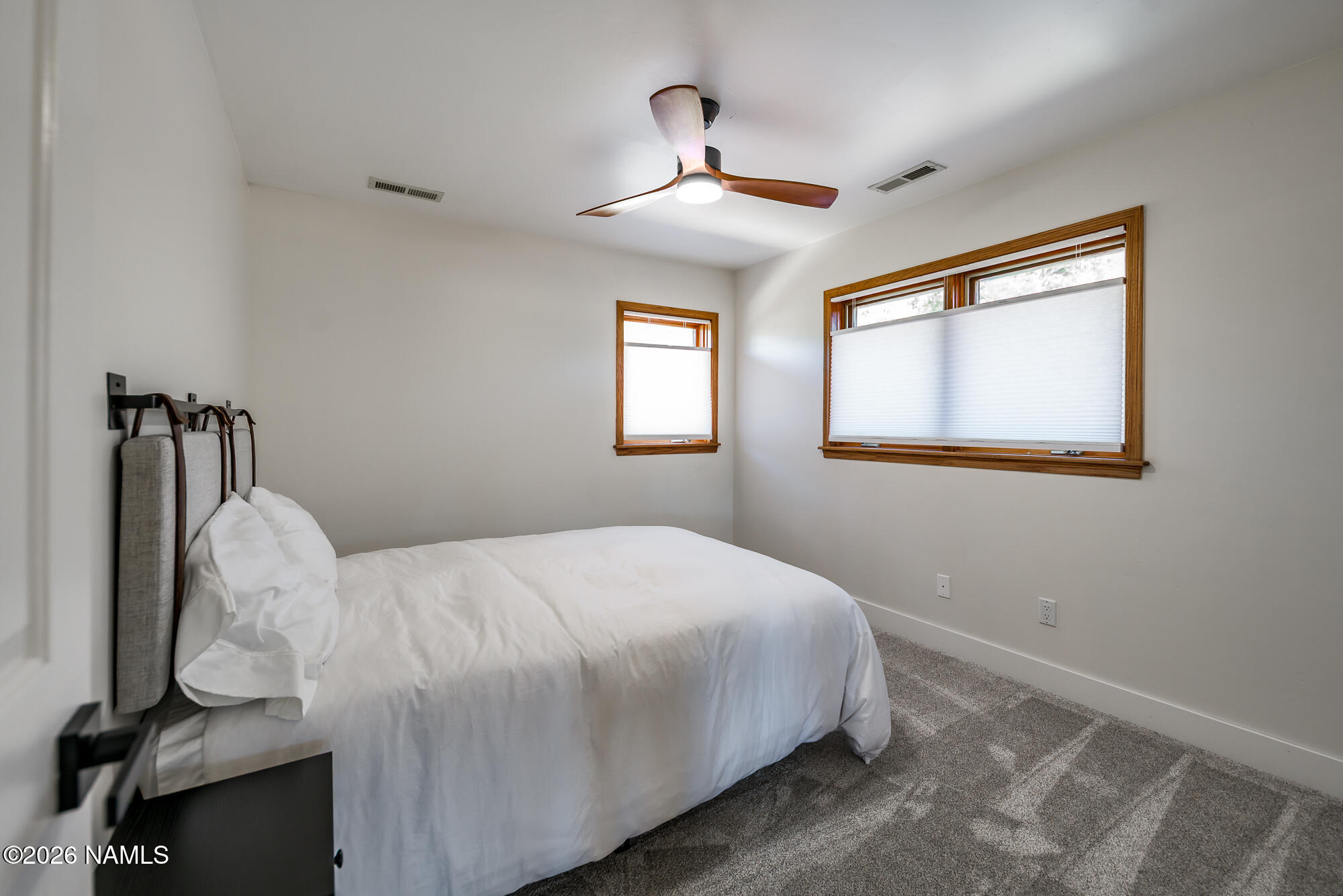 4540 Forest Ranches Loop Parks, AZ 86018 - Photo 26 of 60 a bedroom with a bed and a window