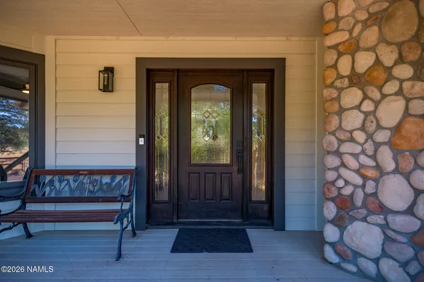 a view of entryway with wooden floor and a front door