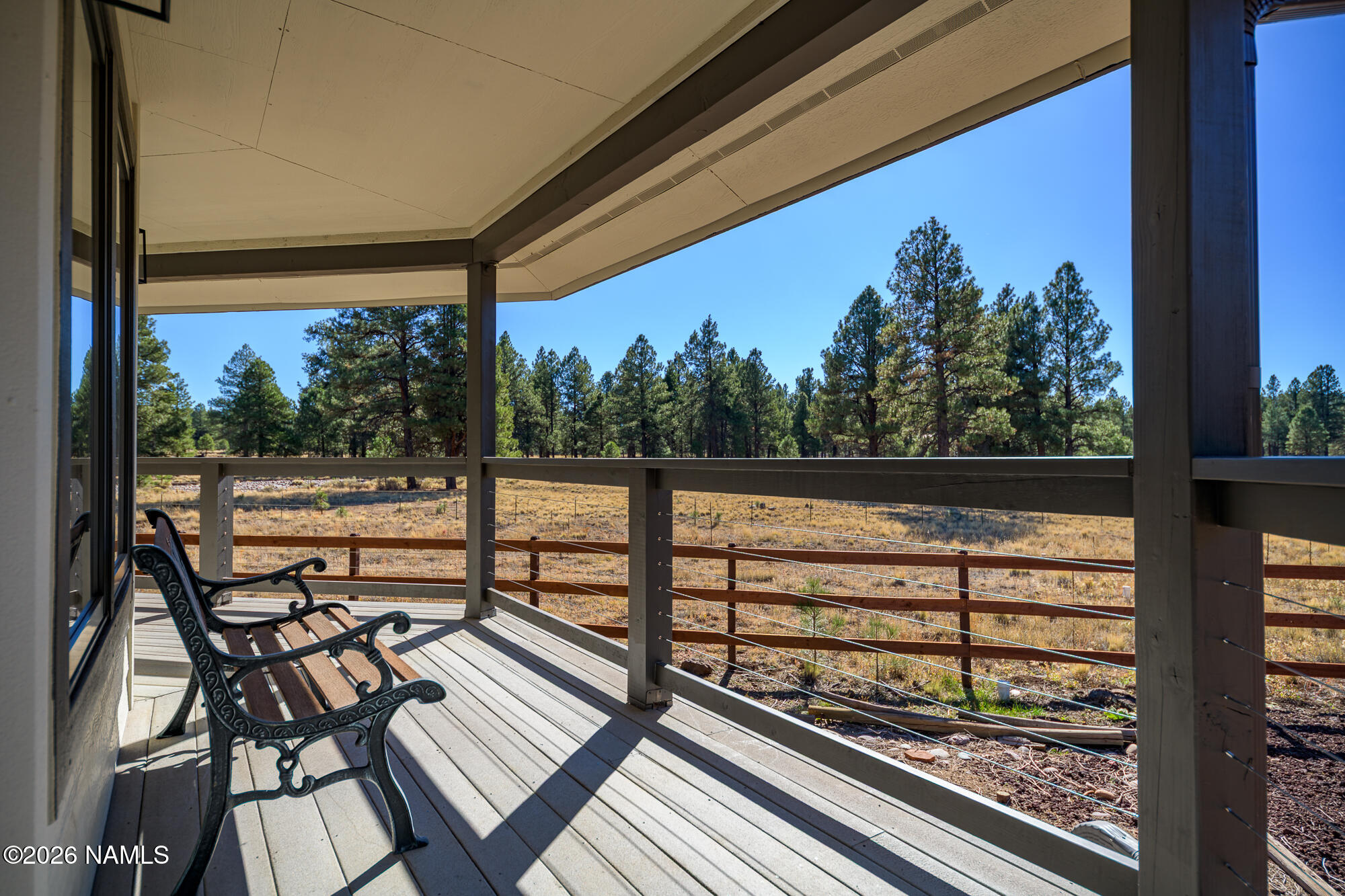 4540 Forest Ranches Loop Parks, AZ 86018 - Photo 31 of 60 a view of a balcony with chairs and wooden floor