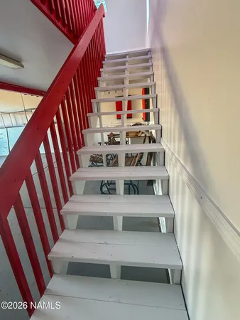 a view of a big house with a large window and a pathway